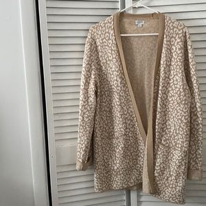 A soft, comfortable, oversized cashmere cardigan. Under butt length.